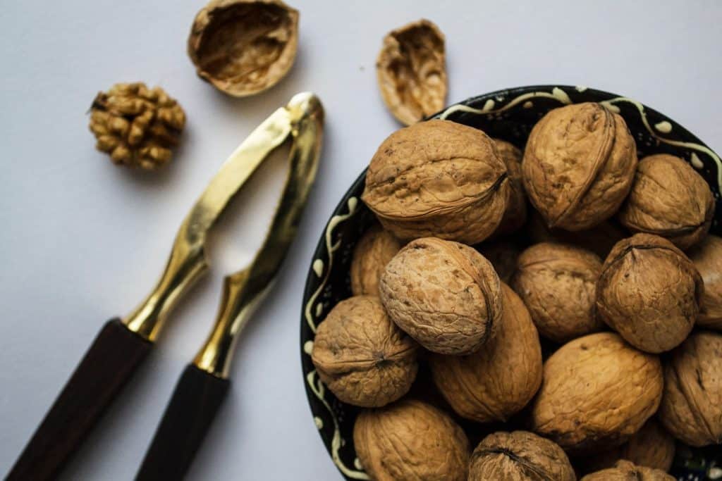 brown nuts on black ceramic bowl