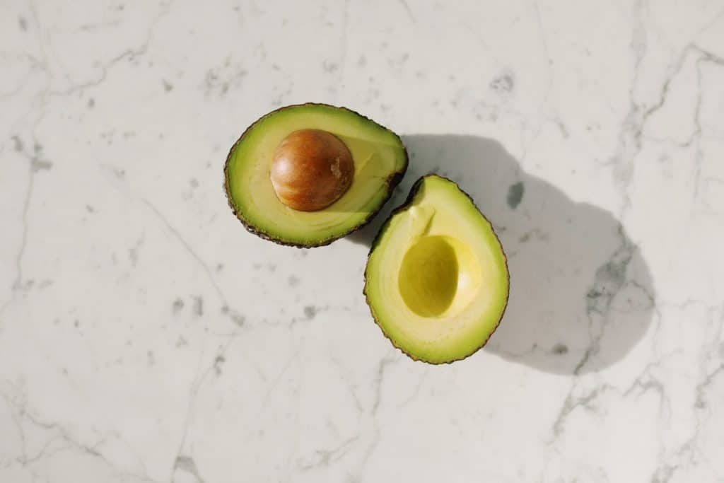 Sliced Green Fruit On White Surface